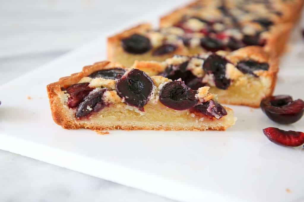 This Cherry Almond Tart is easy and delicious! The almond sablée crust is crunchy and tender, the almond cream filling is soft, and the fresh cherries are baked to jammy perfection!