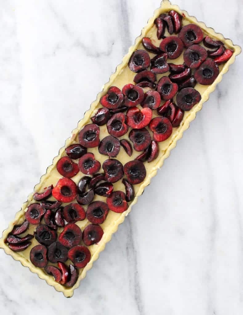 This Cherry Almond Tart is easy and delicious! The almond sablée crust is crunchy and tender, the almond cream filling is soft, and the fresh cherries are baked to jammy perfection!