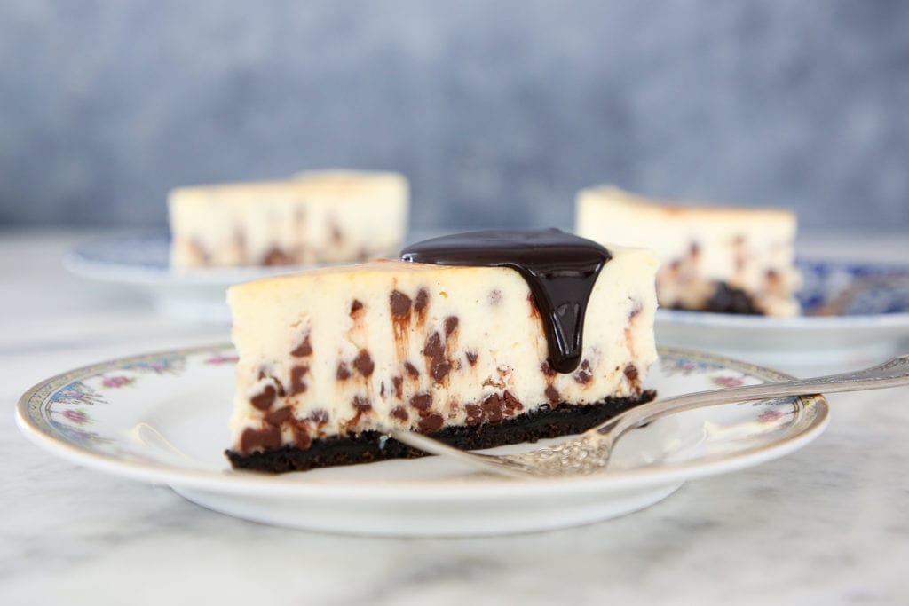 This Chocolate Chip Cheesecake has an easy oreo crust! It is silky and dense, yet surprisingly light! It has the traditional texture and tang of a NY Style Cheesecake!